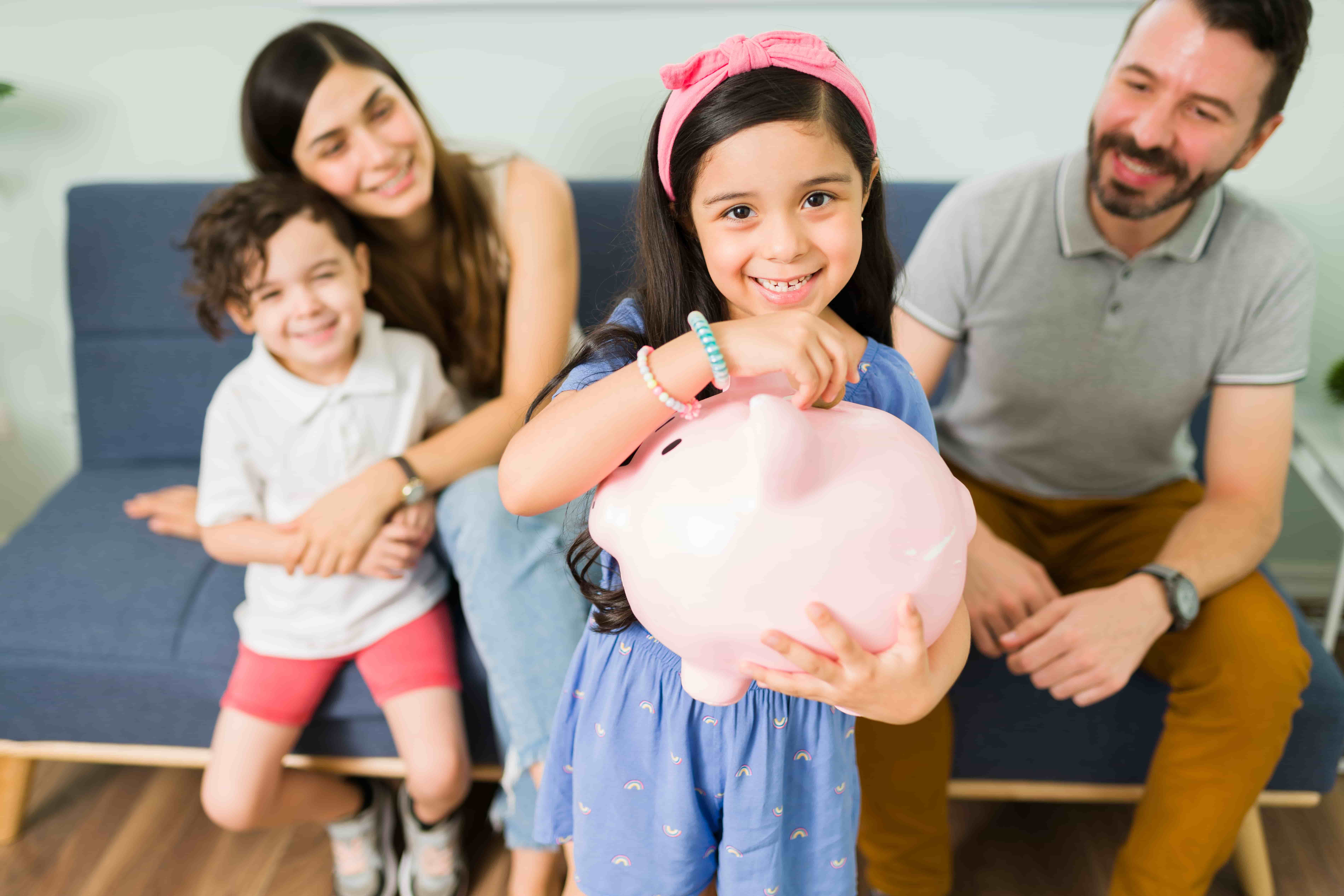 Familie beim Sparen mit Sparschwein